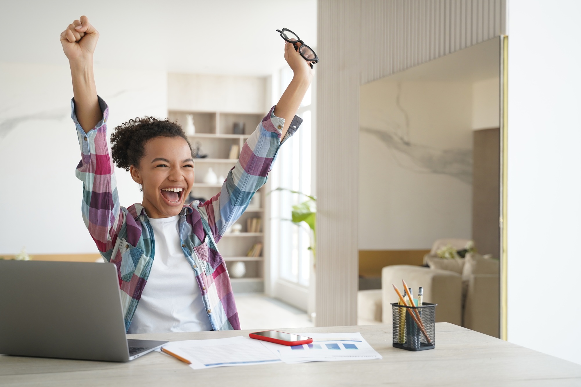 Overjoyed african american student teen girl got email with good exam scores, celebrates success